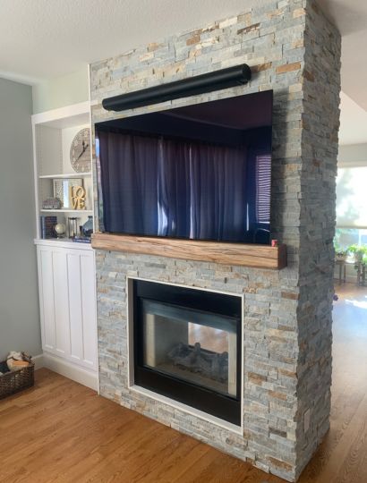 Completed brick fireplace inside a living room in Arvada, CO.