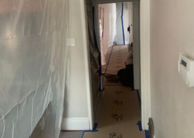 Hallway with plastic wall protection and floor covering during construction work