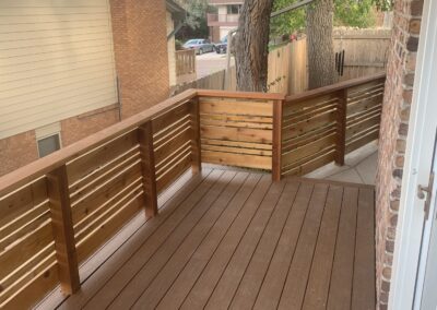 Balcony deck corner with cedar slat railing and composite decking