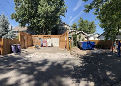 Framed garage walls and cleared lot ready for a new home addition