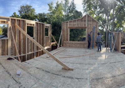 Framers building a new second-story home addition on a rooftop deck